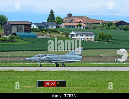 Vintage fighter jet Mirage III landing with a drag parachute, Swiss Air Force, military airfield Payerne, Switzerland Stock Photo