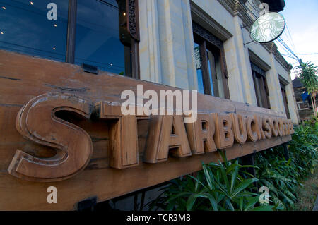 Ubud, Bali, Indonesia - 17th May 2019 : Picture of a wooden Starbucks Coffee signage located in the village of Ubud in Bali, Indonesia Stock Photo