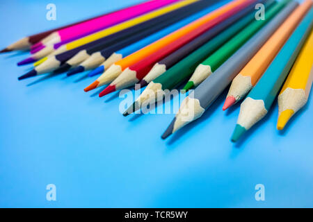 A neatly arranged colored pencil in a blue background Stock Photo