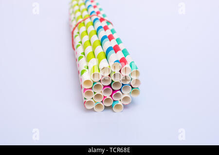 Paper straws bundled up on a white background Stock Photo