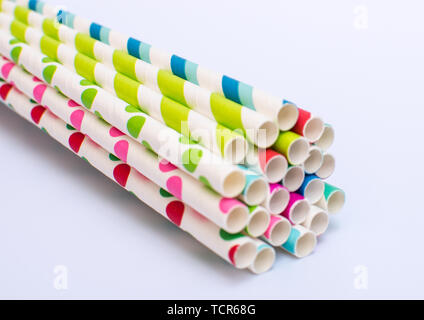 Paper straws bundled up on a white background Stock Photo