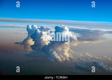 Dramatic Cumulonimbus cloud formations at sunset taken from an aircraft window over southern europe. Stock Photo