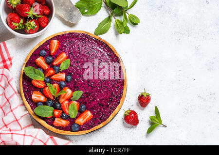 Berry cheesecake on white table top view. Stock Photo