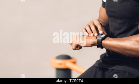 Fitness Gadgets Concept. Man Using Smartwatch After Workout Stock Photo
