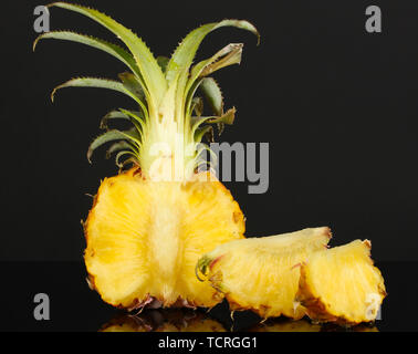 Sliced ripe pineapple isolated on black Stock Photo