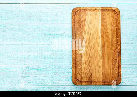 Rectangular wooden cutting board on a wooden background. space for text Stock Photo