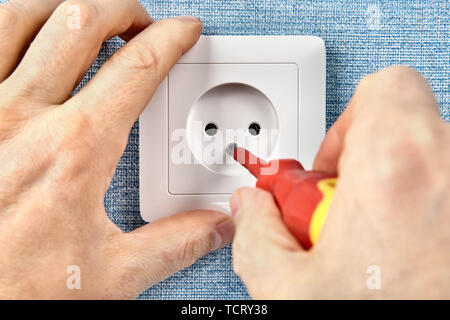 Residential electrical services, installing new power point. Stock Photo