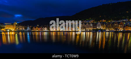 Wide night cityscape of the iconic Bergen harbour ad Bryggen historic district, Norway Stock Photo