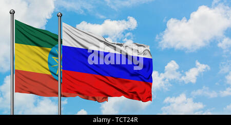 Ethiopia and Russia flag waving in the wind against white cloudy blue sky together. Diplomacy concept, international relations. Stock Photo