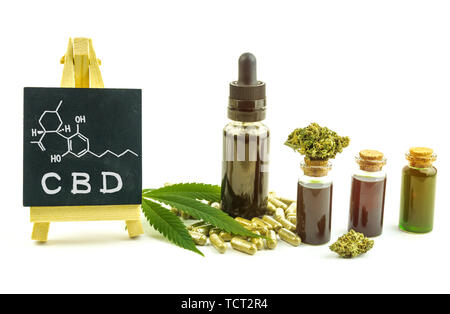 CBD oils, flower buds and pills with small blackboard with Cannabidiol molecular structure isolated Stock Photo