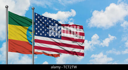 Ethiopia and United States flag waving in the wind against white cloudy blue sky together. Diplomacy concept, international relations. Stock Photo