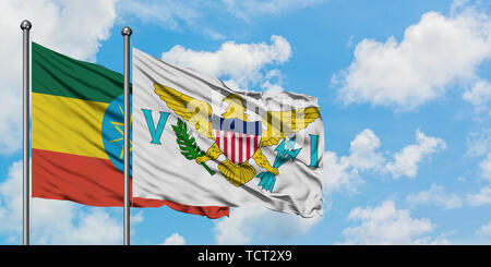 Ethiopia and United States Virgin Islands flag waving in the wind against white cloudy blue sky together. Diplomacy concept, international relations. Stock Photo