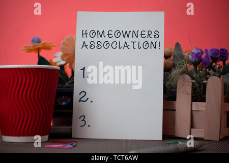 Handwriting text writing Homeowners Association. Conceptual photo Organization with fee for upkeeps of Gated Community Flowers and stationary plus pla Stock Photo