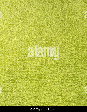 The texture of the fabric is green terry towel. Terry cloth as a background. Close up Stock Photo