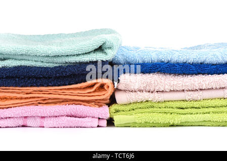 A stack of multi-colored terry towels isolated on a white background. Close up. Copy space Stock Photo