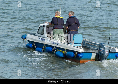 Two men in a volunteer patrol boat on River Dart Dartmouth Stock Photo