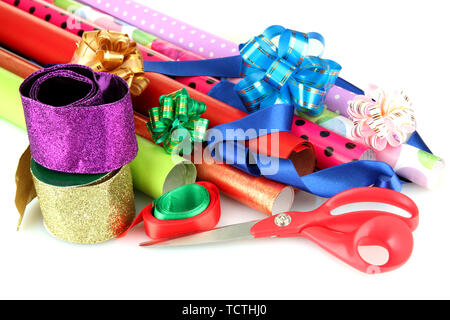 Rolls of Christmas wrapping paper with ribbons, bows isolated on white Stock Photo
