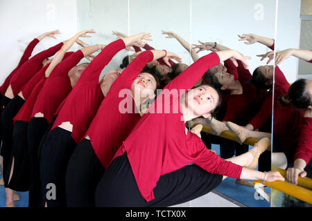 Zaozhuang, China's Shandong Province. 9th June, 2019. Trainees practice leg pressing in Zaozhuang, east China's Shandong Province, June 9, 2019. Long Xuemei was recognized in 2018 as the inheritor of Lu'nan Flower Drum Dance, a provincial intangible cultural heritage in Shandong. Not only does Long have the traditional Lu'nan Flower Drum Dance innovated, but also she trained over 2,000 people, some of whom are performing the dance for tourists at the Taierzhuang ancient town. Credit: Sun Zhongzhe/Xinhua/Alamy Live News Stock Photo