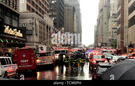 New York, USA. 10th June, 2019. The fire brigade, police and rescue services are on duty near the scene of the accident. At least one person died in a helicopter crash on a skyscraper in New York's Manhattan district. The crash occurred on Seventh Avenue in Manhattan near the famous Times Square. Credit: Benno Schwinghammer/dpa/Alamy Live News Stock Photo