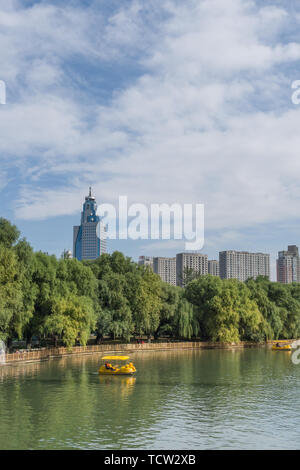 Autumn lakeside forest building cruise ship in Nanhu Park, Shenyang, China Stock Photo