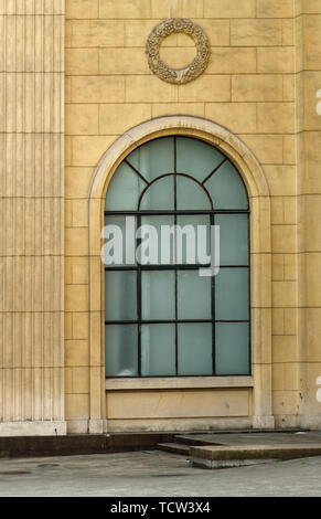 One arched glass window on old red brick wall. Vintage window in brown ...