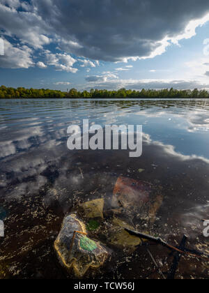 dirty plastic bag contaminating water in river, Riga, Latvia Stock Photo