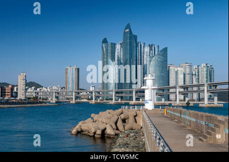 Minlaghang Fisherman Wharf backgrounded by skyscrapers of Marine City in Haeundae District, Gwangandaegyo (Diamond) Bridge in Busan, South Korea Stock Photo