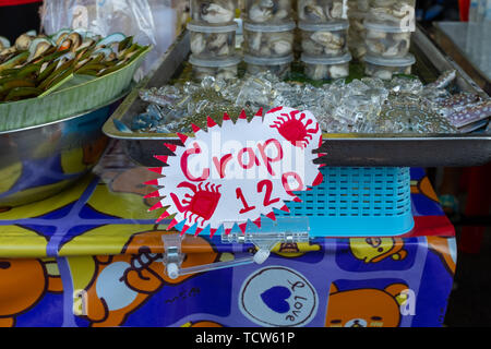 A misspelt food sign at a street food market stall in Krabi, Thailand, the sign reads Crap when it should be Crab, nobody in the image Stock Photo