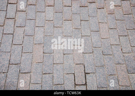 Sand-colored bricks. Stone pavement on the ground for street road. Sidewalk, driveway, cobblestones, sidewalk square pattern. textured background. Stock Photo