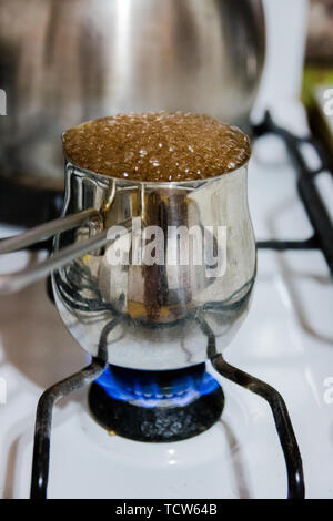 https://l450v.alamy.com/450v/tcw64b/turkish-coffee-pot-and-coffee-boiling-on-gas-stove-strong-drink-tcw64b.jpg