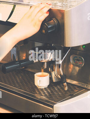 pouring coffee from the coffee machine Stock Photo
