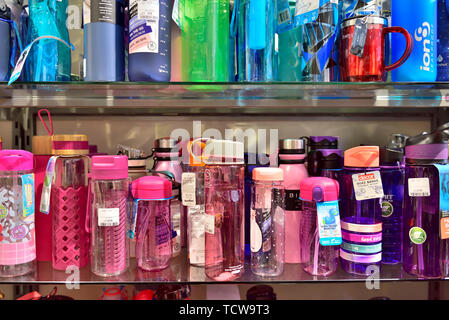 Display of refillable environmentally friendly drinking water bottles on shelves for sale in shop Stock Photo