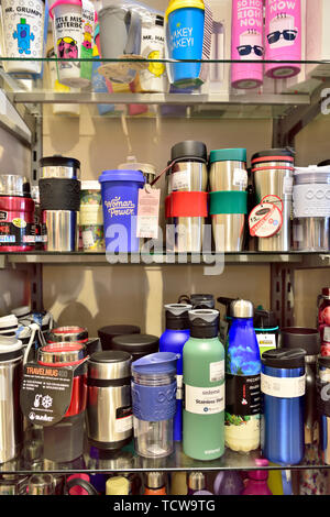 Display of refillable environmentally friendly drinking water bottles on shelves for sale in shop Stock Photo