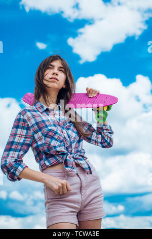 plastic mini cruiser board. Spring. Urban scene, city life. skateboard sport hobby. Summer activity. ready to ride on the street. Hipster girl with pe Stock Photo