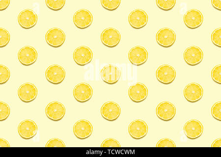 Lemon slices seamless pattern on pastel yellow background. Minimal summer concept. Flat lay, trendy juicy color. Stock Photo