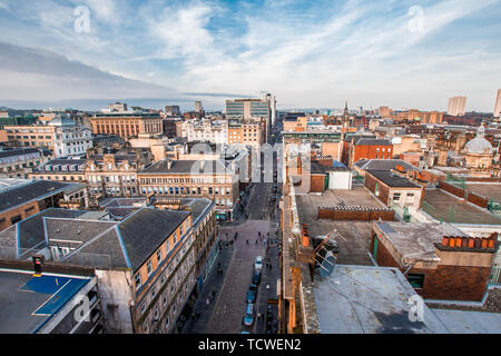 A wide view looking down on a street, buildings and rooftops in Glasgow city center, Scotland, United Kingdom.