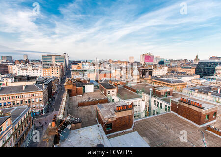 A wide view looking down on a street, buildings and rooftops in Glasgow city center, Scotland, United Kingdom.