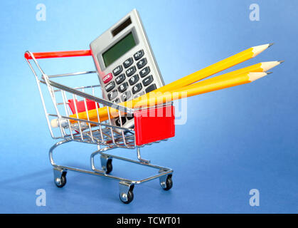 trolley with school equipment on blue background Stock Photo