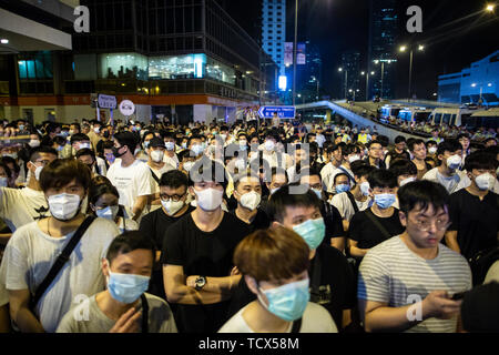 Demonstrators seen occupying a major road outside the legislative council building.  In the early hours of 10th of June hundreds of demonstrators clashed with the police as the demonstrators attempted to occured the entrance of the legislative council building where the legislative council members are set to vote on the extradition bill on the 12 of June. The clashes has caused at least 15 people injured including protesters, police officer and members of the press. Hundreds of thousands of demonstrators took to the street of Hong Kong on the 9th of June before the clashes happened to protest  Stock Photo