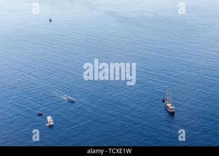 Top view of a white boat sailing in the blue sea. Romantic vacation by the sea Stock Photo