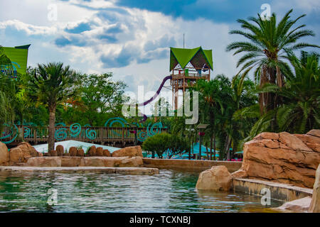 Orlando, Florida. April 7, 2019. Beautiful view of Aquatica Tower, slide , palm trees and pool on cloudy sky background in International Drive area . Stock Photo