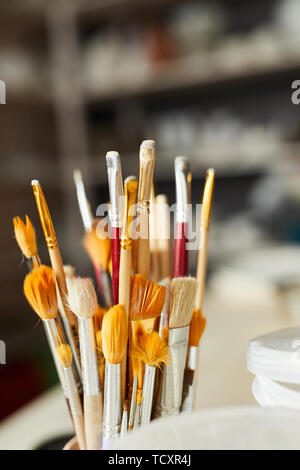 Close up of paintbrushes on table in art studio, copy space Stock Photo