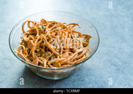 Spiralized Raw Sweet Potato Salad with Tahini / Tahin Sauce, Walnut and Cheese in Glass Bow.l. Organic Food. Stock Photo