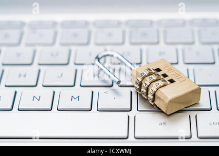 An open lock on a computer keyboard. Stock Photo