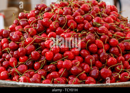 Red fresh ripe sweet cherry on metal tray Stock Photo