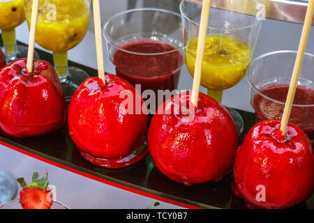 Red caramel apples on the wooden sticks Stock Photo