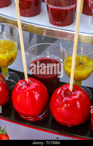 Red caramel apples on the wooden sticks Stock Photo