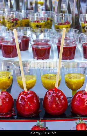 Red caramel apples on the wooden sticks Stock Photo