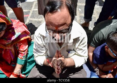 A devotee prays at the Kheer Bhawani temple during the annual Hindu festival in Ganderbal district, about 30kms northeast of Srinagar, Kashmir. Thousands of Kashmiri Hindus, many of whom were displaced 20 years ago, attended the festival in order to worship the Hindu goddess Mata Kheer Bhawani on the day of her birth.  Some 200,000 Kashmiri Pandits fled the region in the early nineties at the start of an insurgency against Indian rule mainly to the Hindu-dominated southern city of Jammu and they return yearly for the festival. Stock Photo