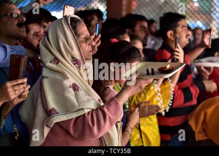 A devotee performs rituals at the Kheer Bhawani temple during the annual Hindu festival in Ganderbal district, about 30kms northeast of Srinagar, Kashmir. Thousands of Kashmiri Hindus, many of whom were displaced 20 years ago, attended the festival in order to worship the Hindu goddess Mata Kheer Bhawani on the day of her birth.  Some 200,000 Kashmiri Pandits fled the region in the early nineties at the start of an insurgency against Indian rule mainly to the Hindu-dominated southern city of Jammu and they return yearly for the festival. Stock Photo